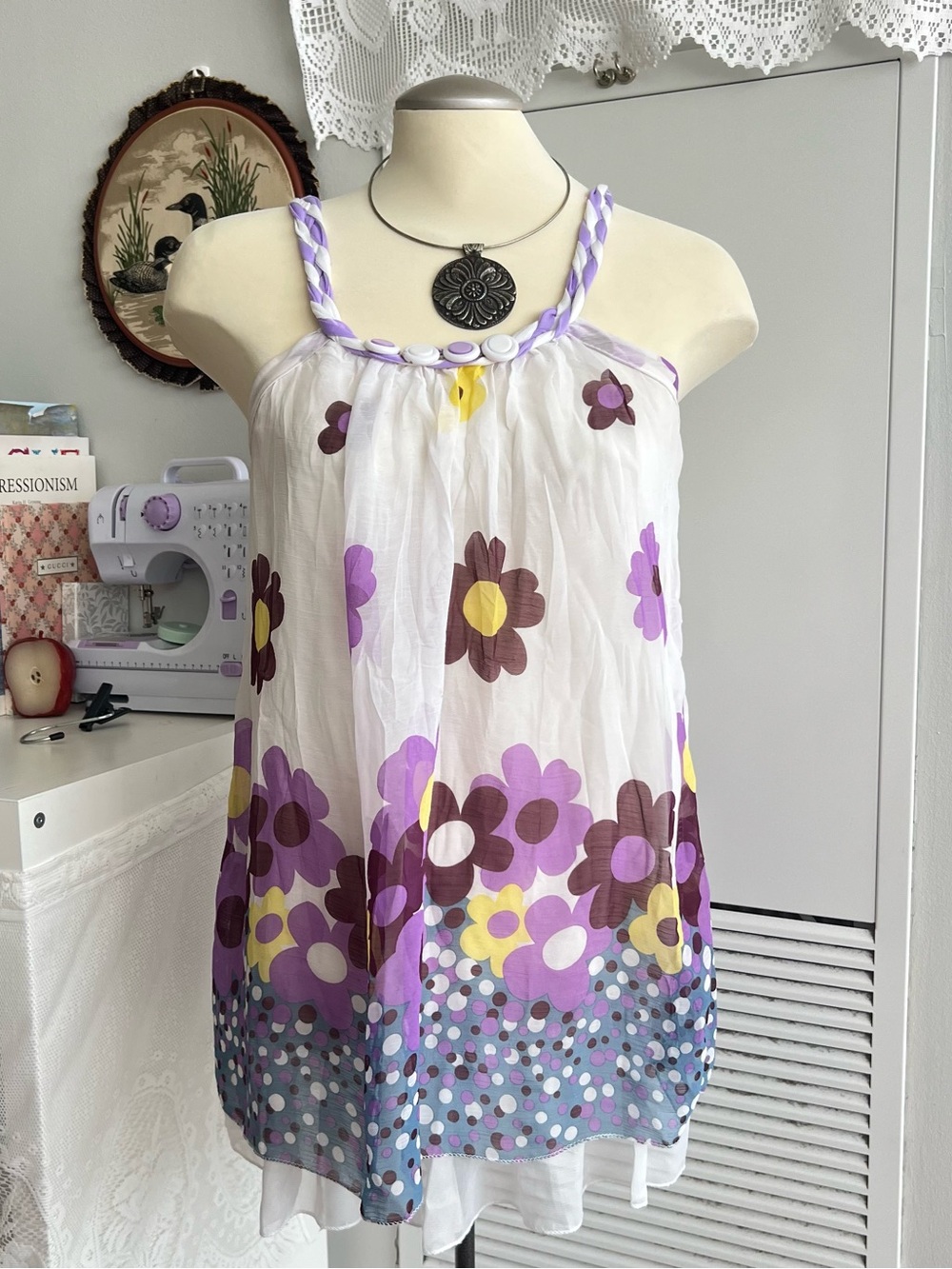 Purple, yellow, and brown floral halter top with white polka dots on the hem